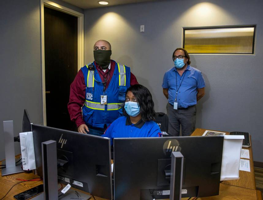 Jessica Brown, front, monitors the numerous RTC camera feeds within the control center at the B ...