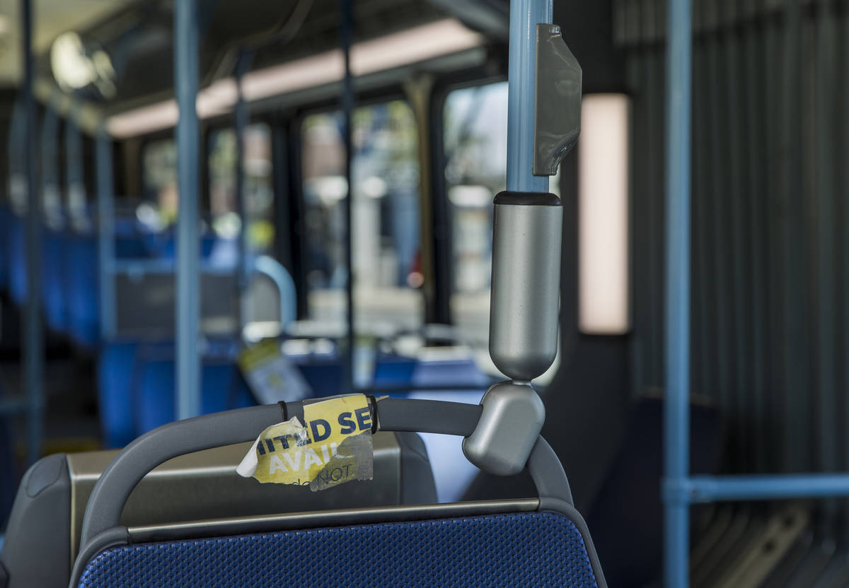 A sign notifying bus passengers that a seat is unavailable due to social distancing measures ha ...