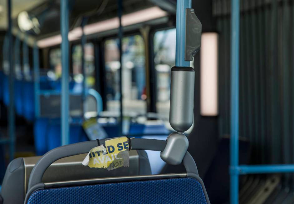 A sign notifying bus passengers that a seat is unavailable due to social distancing measures ha ...