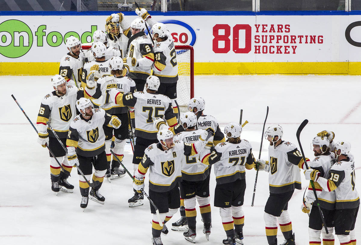 Vegas Golden Knights players celebrate their 5-3 win over the Vancouver Canucks after an NHL We ...
