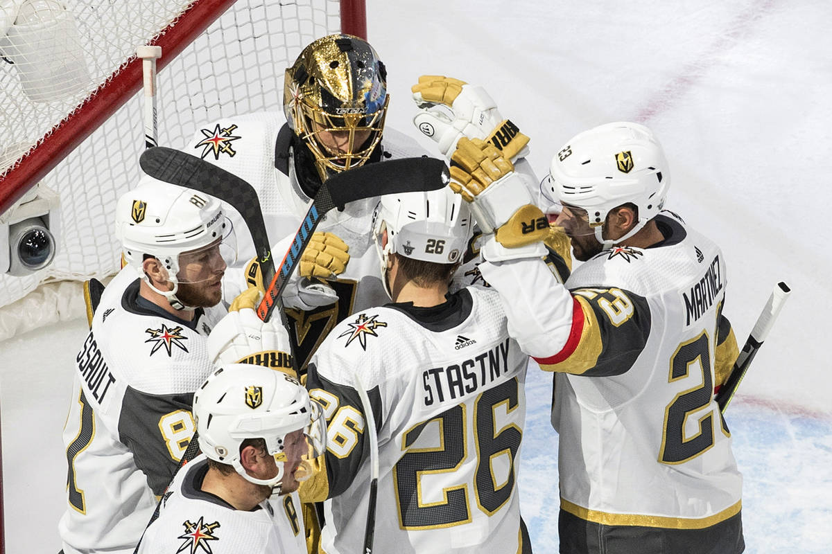 Vegas Golden Knights players celebrate their 5-3 win over the Vancouver Canucks after an NHL We ...