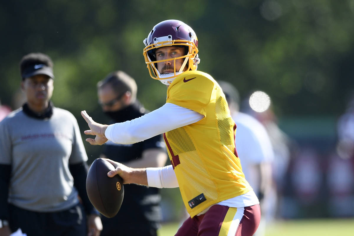 Washington quarterback Alex Smith (11) looks to pass during practice at the team's NFL football ...