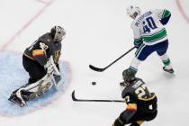 Vegas Golden Knights goalie Robin Lehner (90) stops Vancouver Canucks' Elias Pettersson (40) as ...