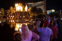People on the Strip watch the first volcano show since the opening of the The Mirage earlier in ...