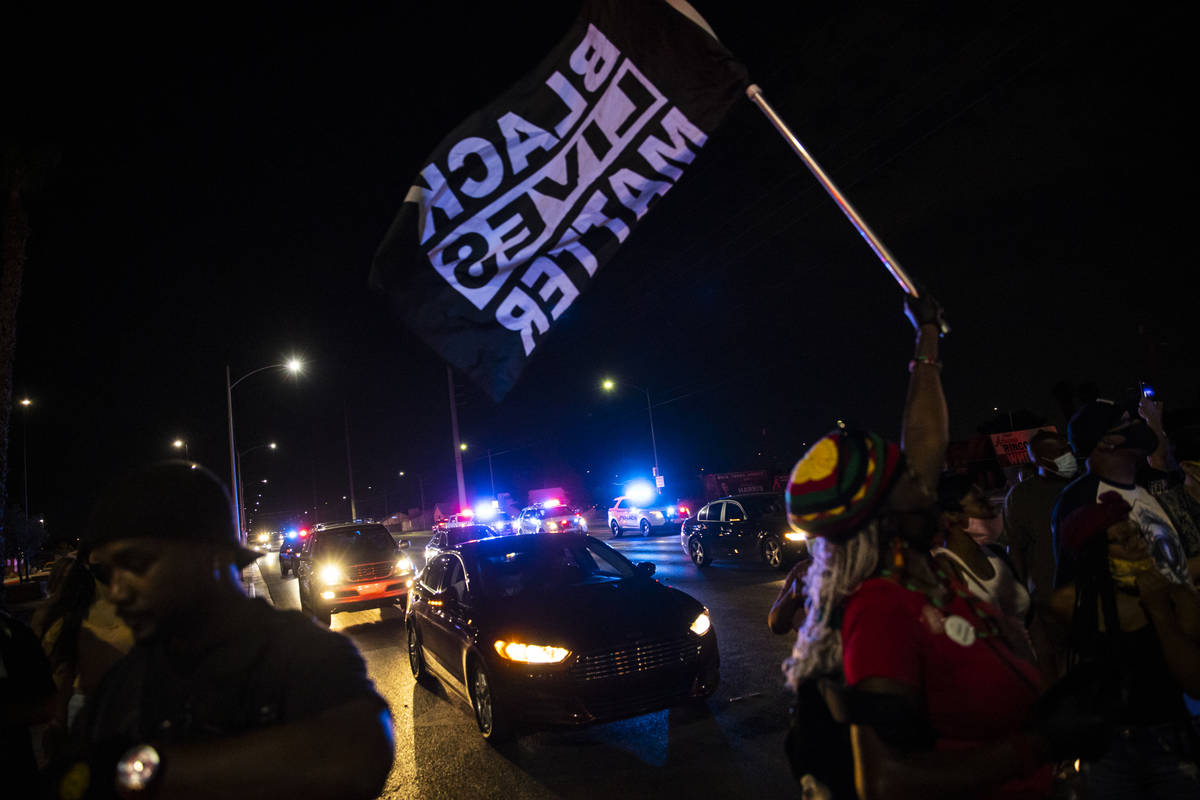 People stop traffic during a rally against police brutality by the Martin Luther King Jr. statu ...