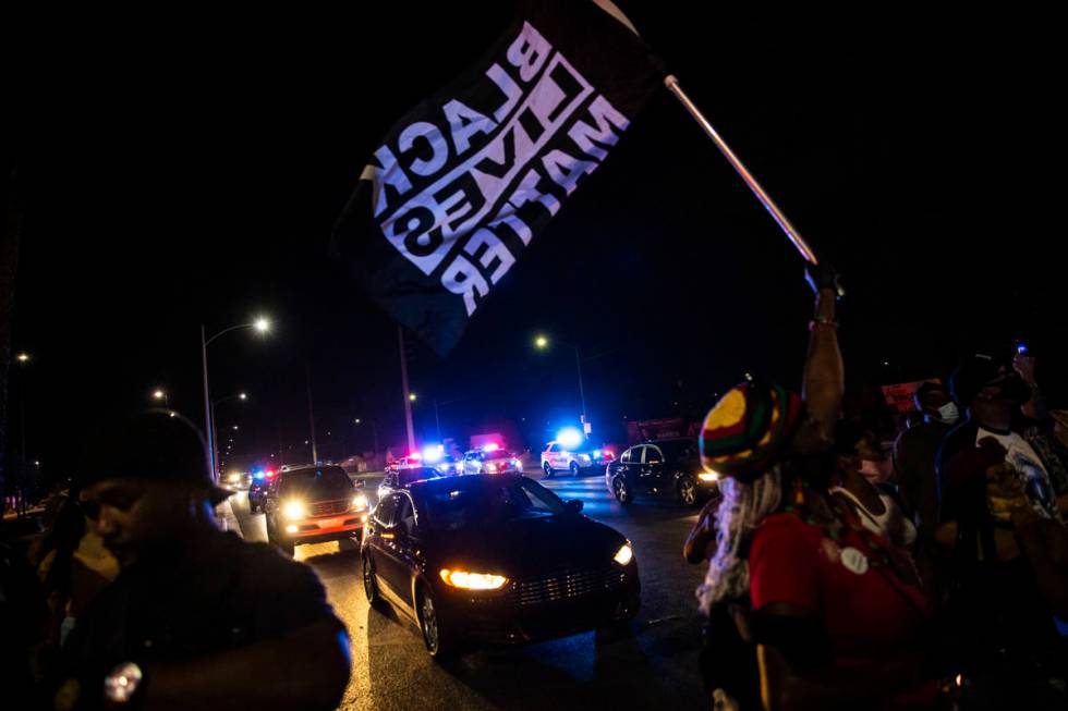 People stop traffic during a rally against police brutality by the Martin Luther King Jr. statu ...