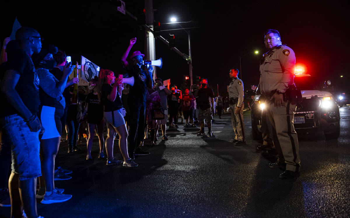 People stop traffic as police look on during a rally against police brutality by the Martin Lut ...
