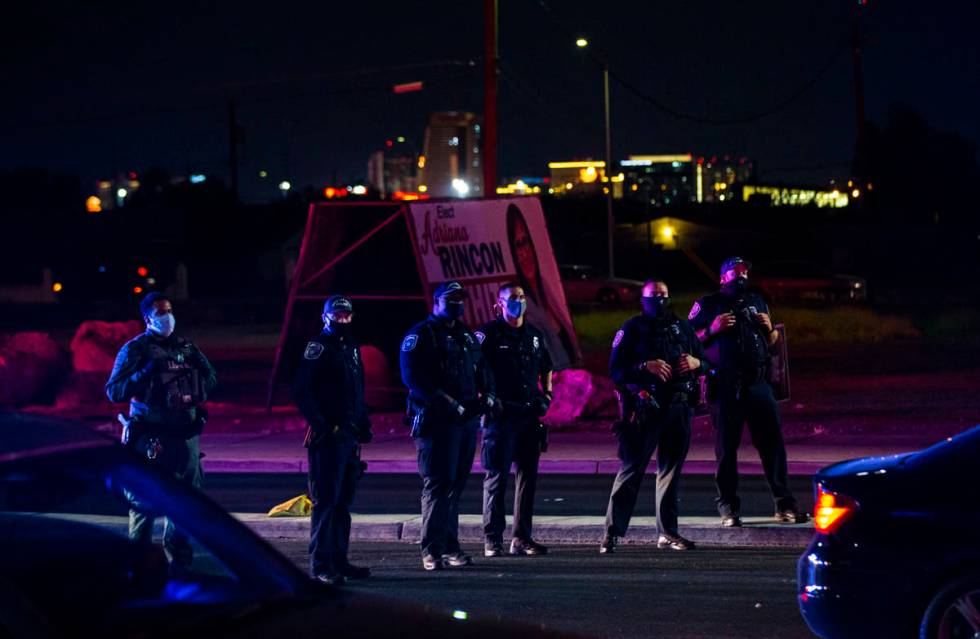 North Las Vegas police look on as protesters stop traffic during a rally against police brutali ...