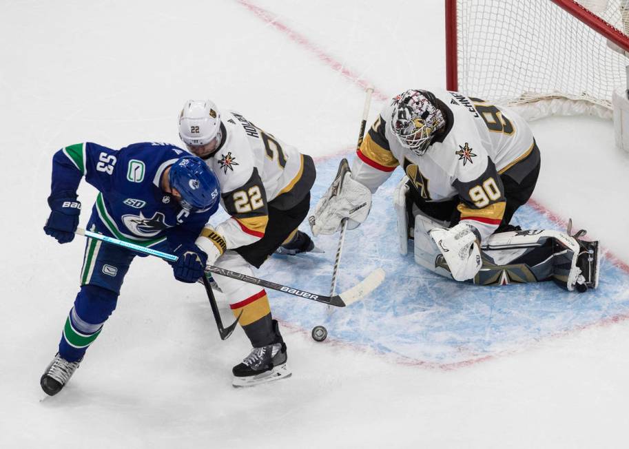 Vegas Golden Knights goalie Robin Lehner (90) makes a save on Vancouver Canucks' Bo Horvat (53) ...