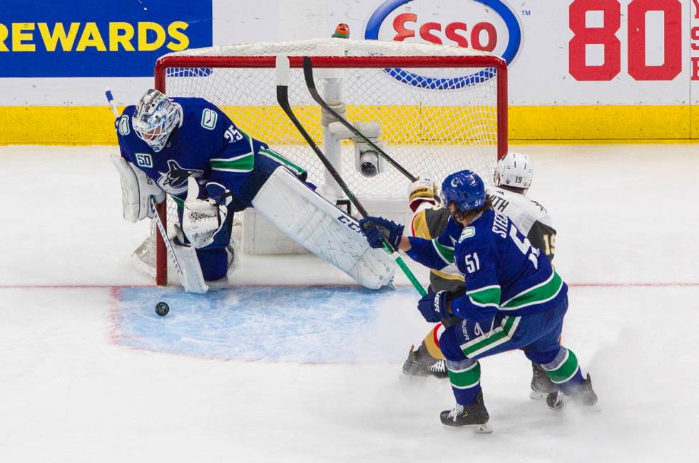 Vegas Golden Knights' Reilly Smith (19) is stopped by Vancouver Canucks goalie Jacob Markstrom ...