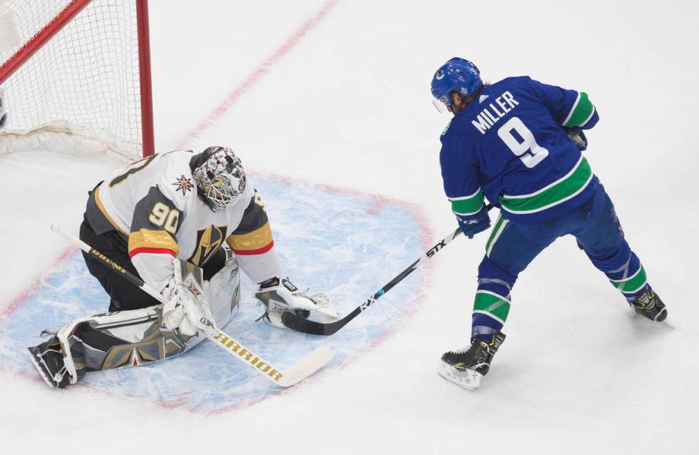 Vegas Golden Knights goalie Robin Lehner (90) makes a save on Vancouver Canucks center J.T. Mil ...