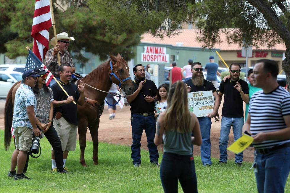 People participating in a No Mask Nevada PAC rally pose for a photo at Sunset Park in Las Vegas ...