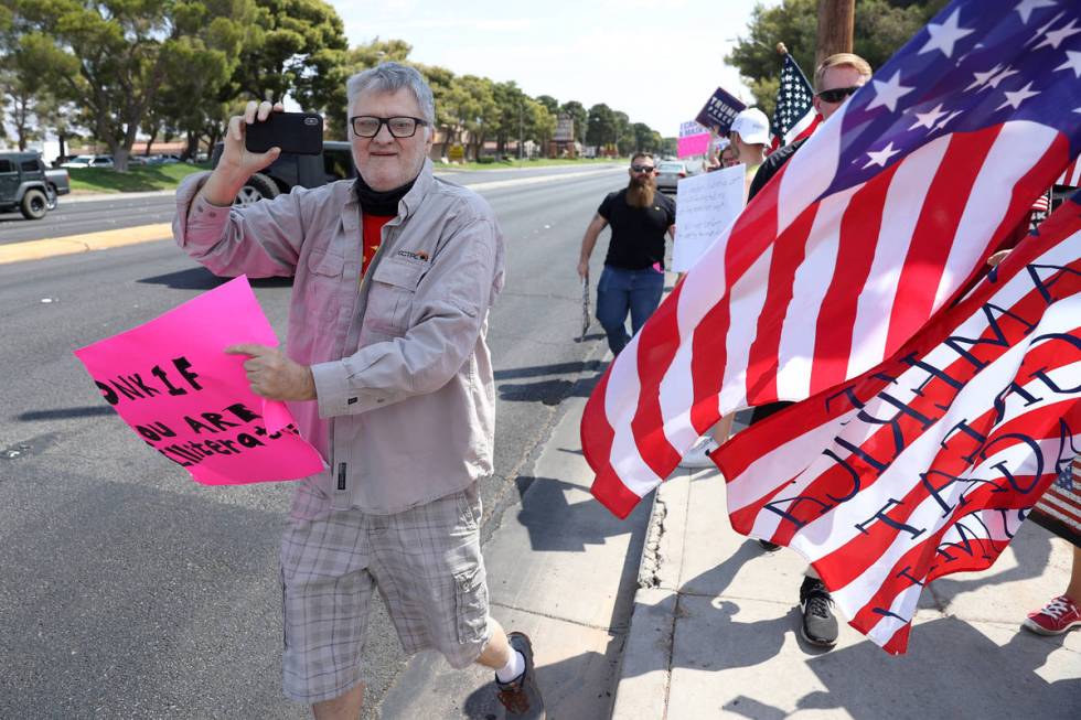 A counterprotester at a No Mask Nevada PAC rally at Sunset Park in Las Vegas, Saturday, Aug. 29 ...