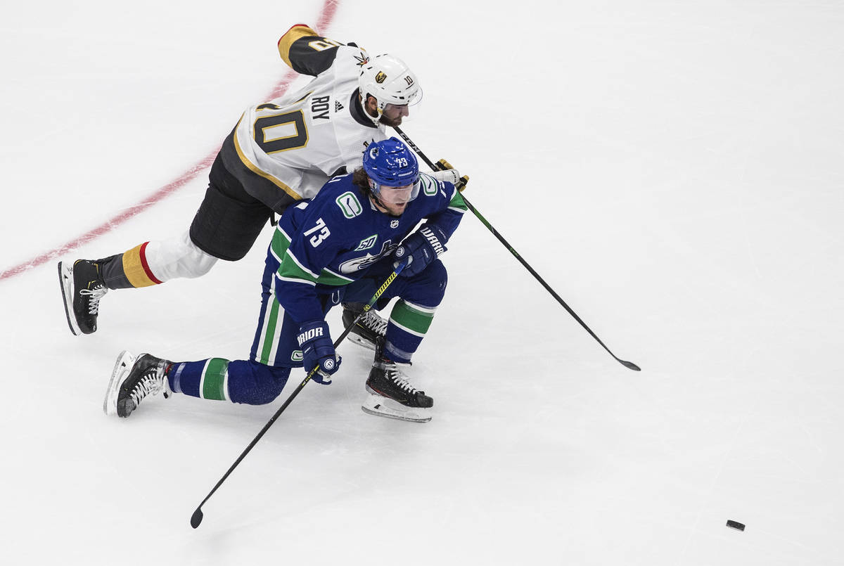 Vegas Golden Knights' Nicolas Roy (10) and Vancouver Canucks' Tyler Toffoli (73) viefor the puc ...
