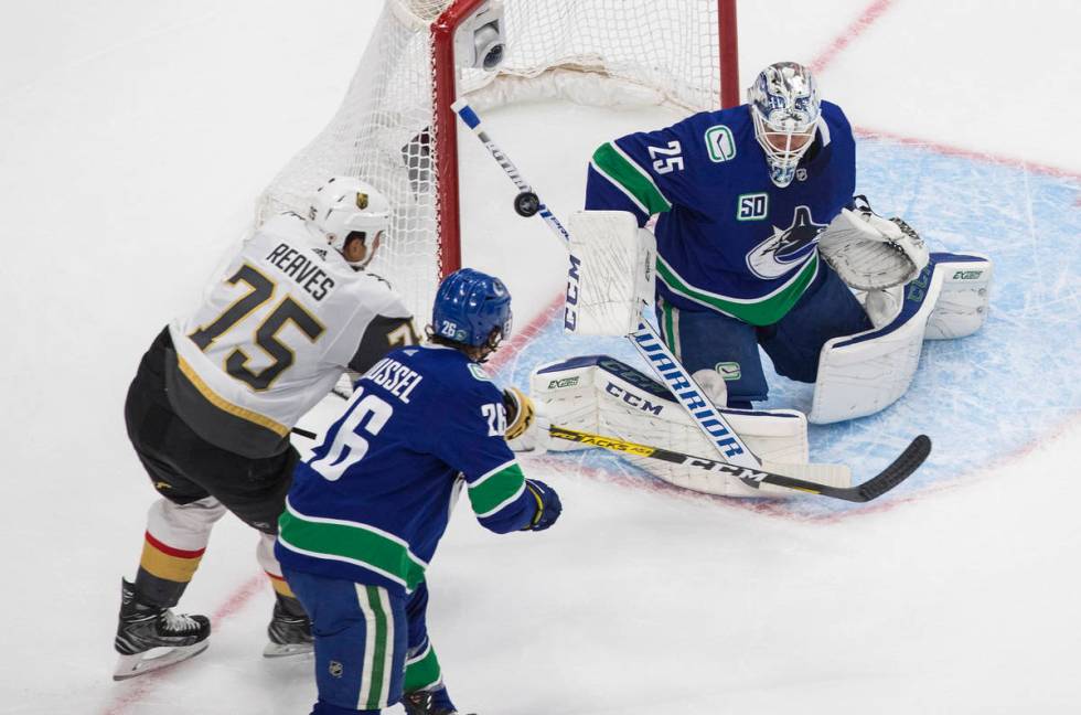 Vegas Golden Knights' Ryan Reaves (75) is stopped by Vancouver Canucks goalie Jacob Markstrom ( ...