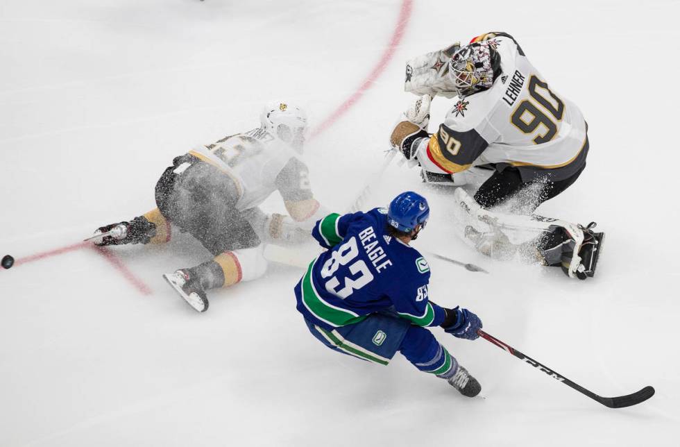 Vegas Golden Knights goalie Robin Lehner (90) makes the save on Vancouver Canucks' Jay Beagle ( ...