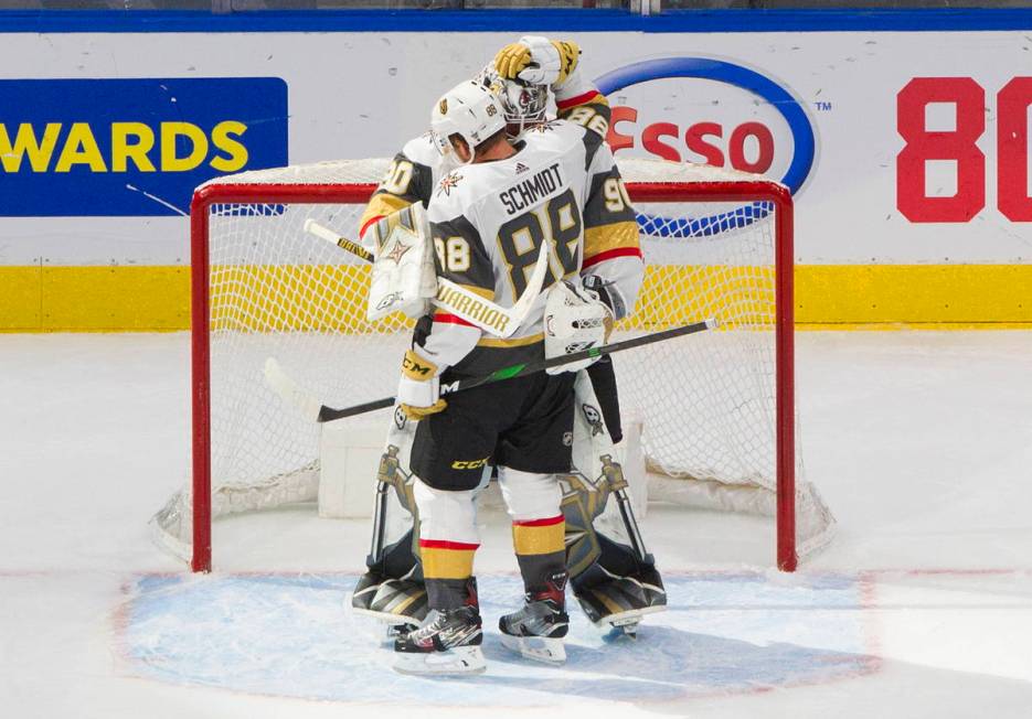 Vegas Golden Knights' Nate Schmidt (88) and goalie Robin Lehner (90) celebrate the team's win o ...