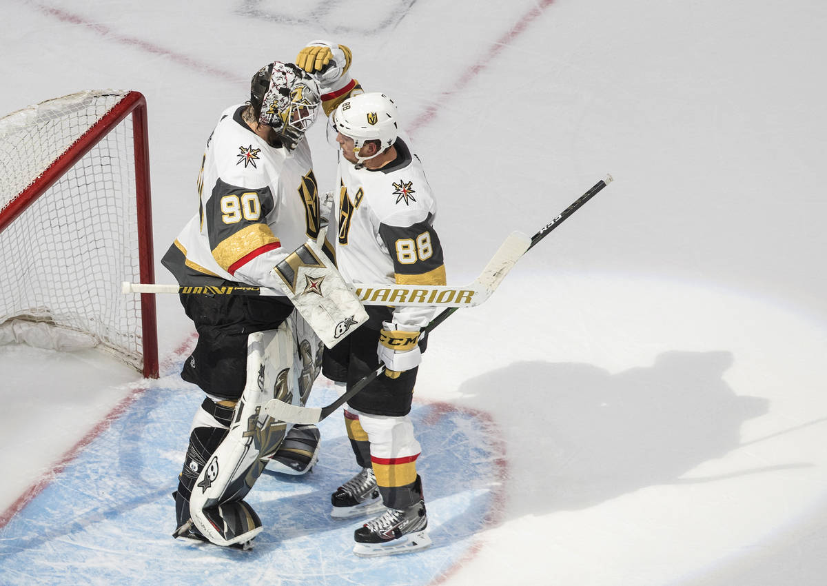 Vegas Golden Knights goalie Robin Lehner (90) and teammate Nate Schmidt (88) celebrate the team ...