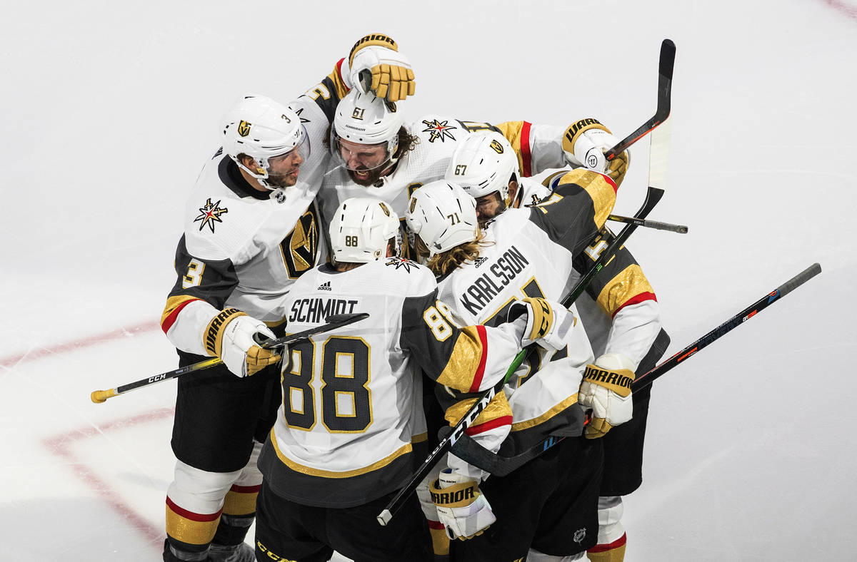 Vegas Golden Knights players celebrate a goal against the Vancouver Canucks during the third pe ...