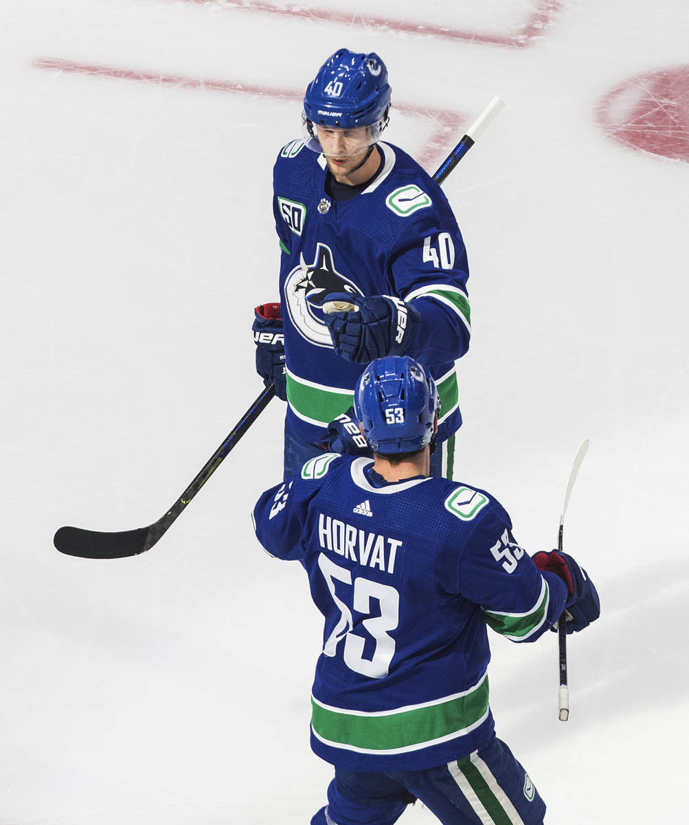 Vancouver Canucks' Elias Pettersson (40) celebrates his goal with teammate Bo Horvat (53) again ...