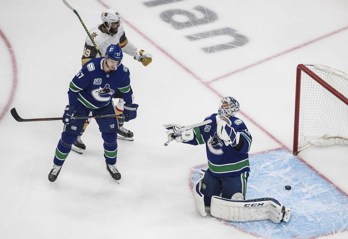 Vegas Golden Knights' Alex Tuch (89) reacts as Vancouver Canucks goalie Jacob Markstrom (25) is ...