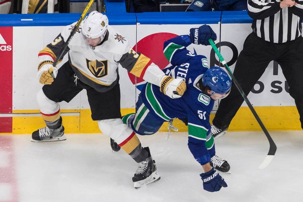 Vegas Golden Knights defenseman Brayden McNabb (3) checks Vancouver Canucks defenceman Troy Ste ...