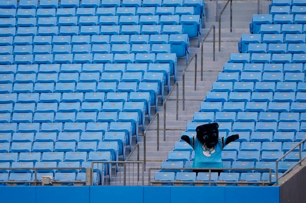 The Carolina Panthers mascot cheers to an empty stadium during an NFL football camp practice We ...