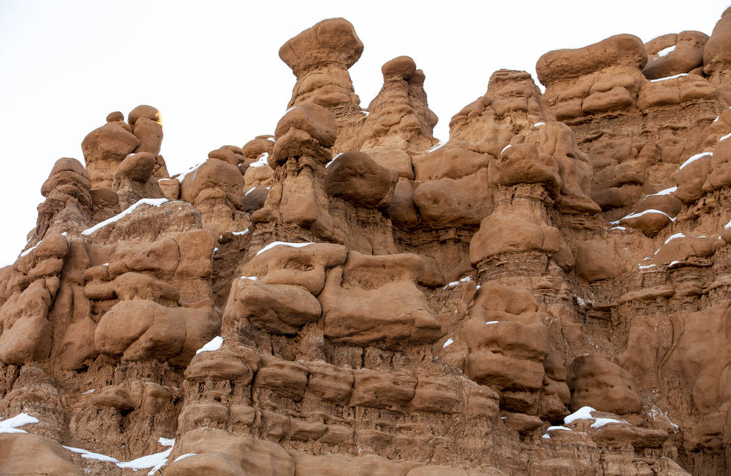 Snow tops some of the thousands of hoodoos, called goblins, in Goblin Valley State Park in Utah ...