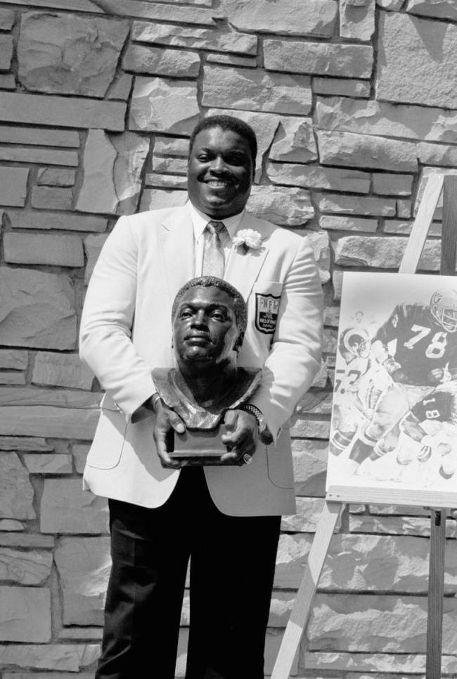 Former Oakland Raiders great Art Shell poses with his bust after being inducted into the Footba ...