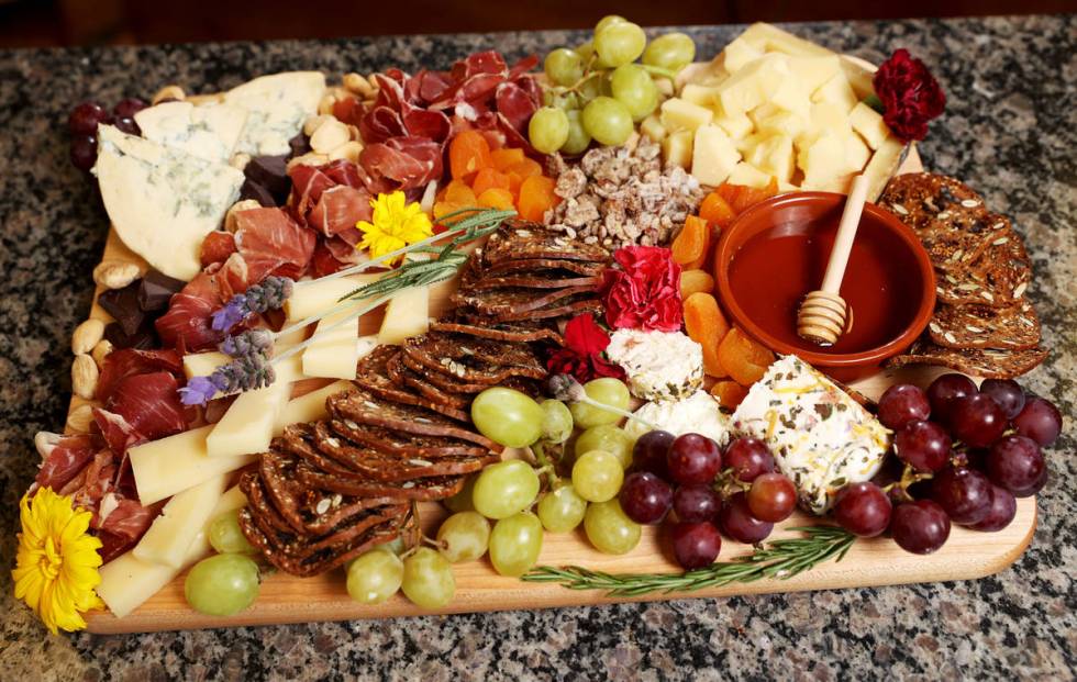 A good cheese board includes three to four cheeses that balance flavors and textures, delivery ...