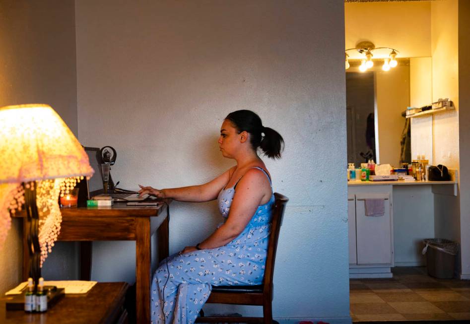 Alisha Burns works on her case at her apartment in Boulder City on Aug. 18, 2020. She wants a j ...