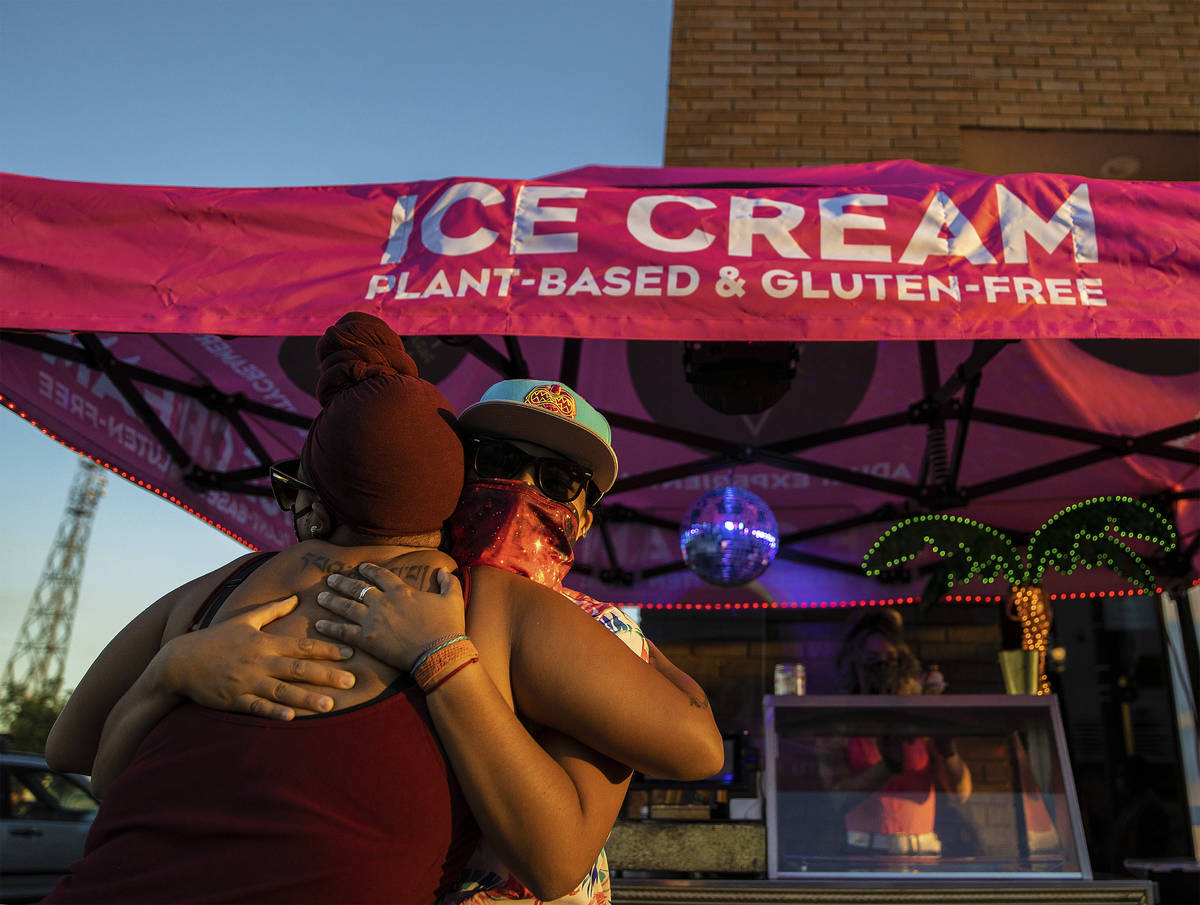 Production manager Angie Ortaliza, right, hugs a customer at Paradise City Creamery on Friday, ...