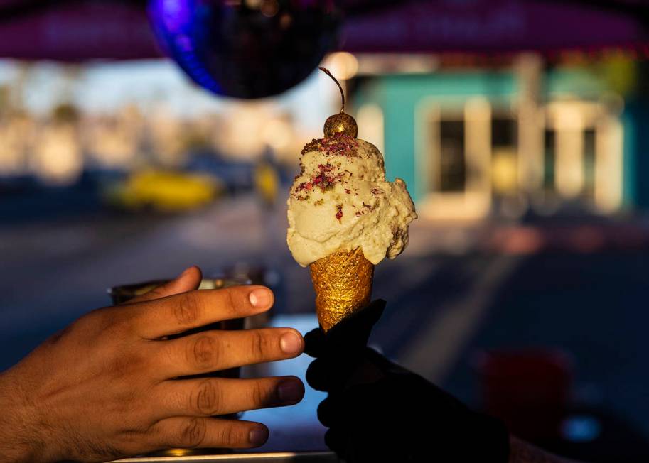 Founder and head creamstress Valerie Stunning, right, hands Elijah Armstrong an ice cream cone ...