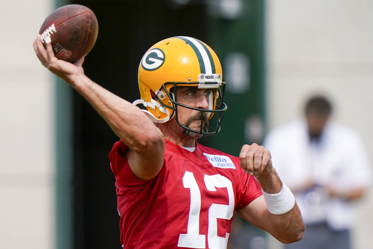 Green Bay Packers' Aaron Rodgers throws during NFL football training camp Saturday, Aug. 15, 20 ...