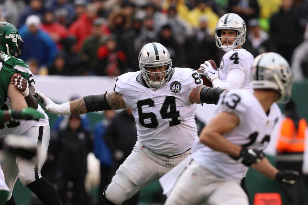 Oakland Raiders offensive guard Richie Incognito (64) blocks as quarterback Derek Carr (4) look ...