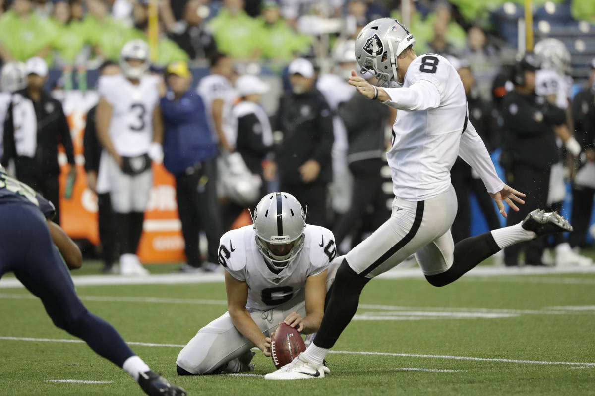 Oakland Raiders kicker Daniel Carlson (8) kicks a field goal as punter A.J. Cole holds during t ...