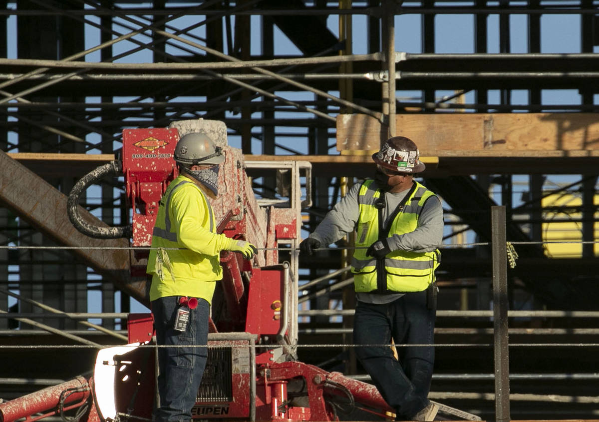 Construction workers chat at the Resorts World construction site, on Monday, Aug. 31, 2020, in ...