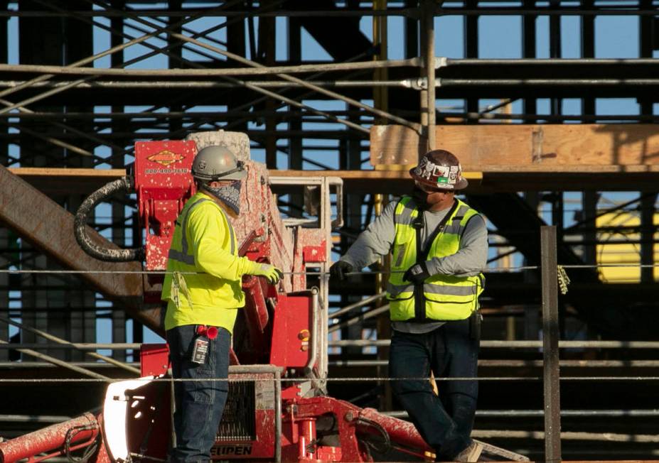 Construction workers chat at the Resorts World construction site, on Monday, Aug. 31, 2020, in ...