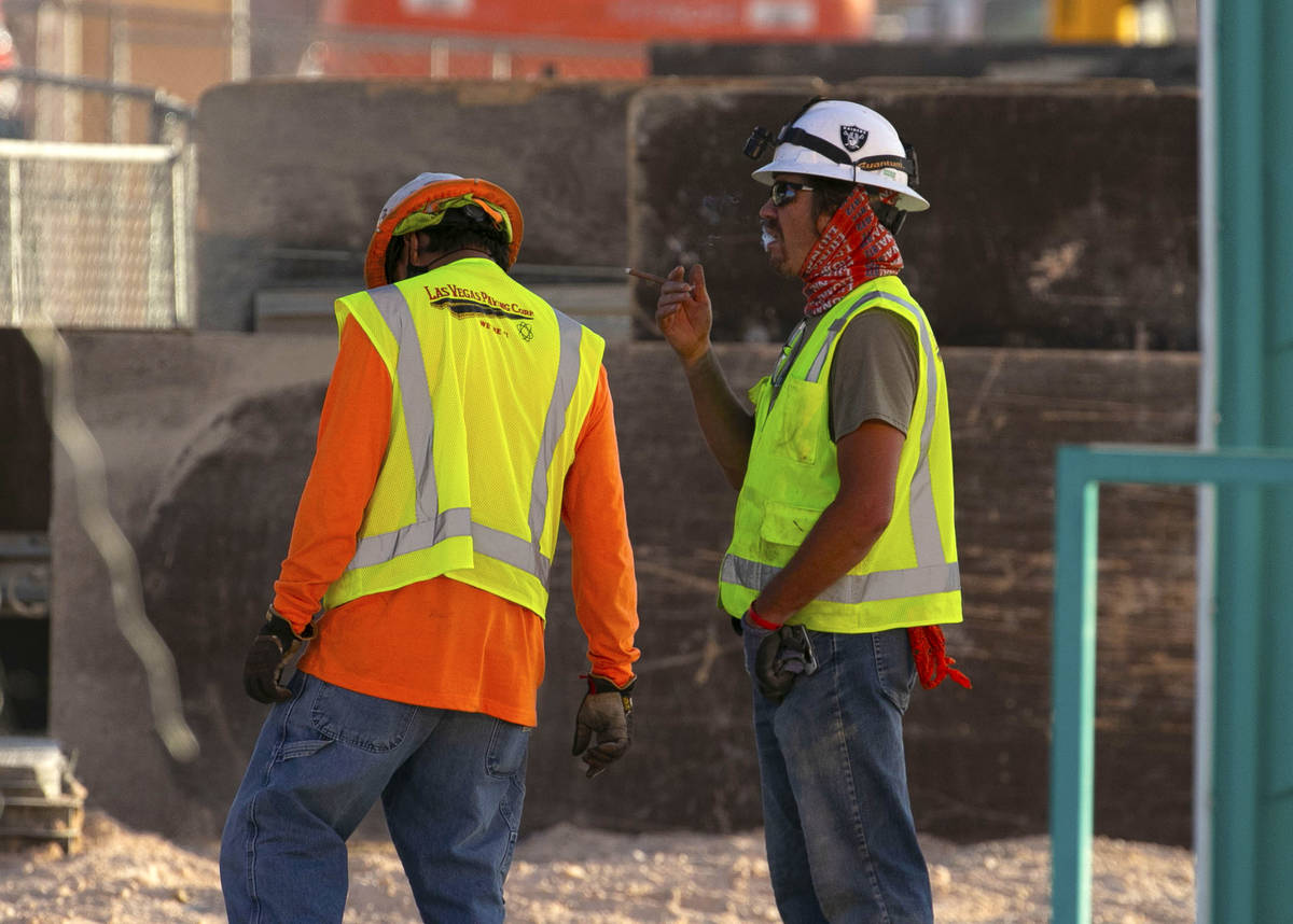 Construction workers take a break at the Resorts World construction site, on Monday, Aug. 31, 2 ...