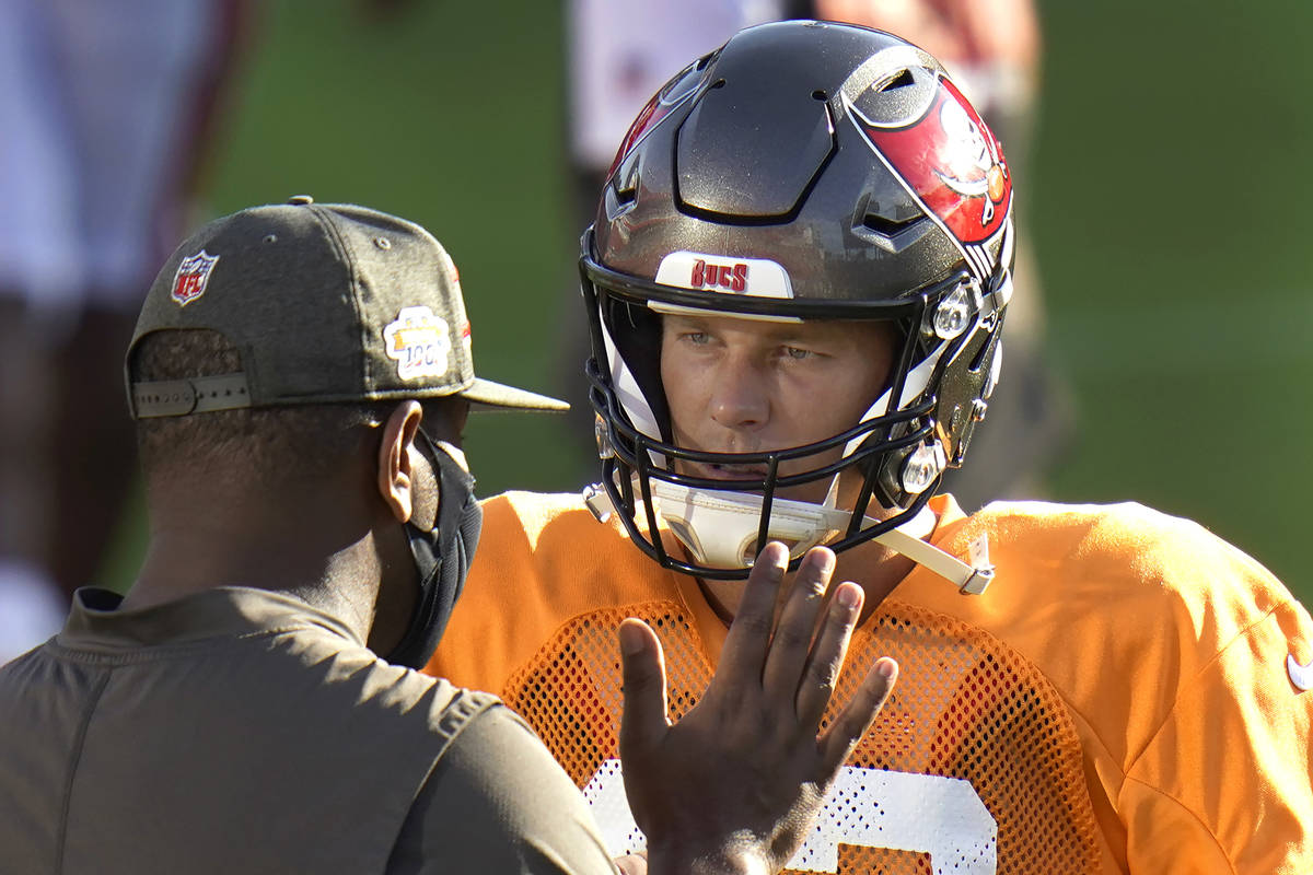 Tampa Bay Buccaneers quarterback Tom Brady talks to offensive coordinator Byron Leftwich during ...