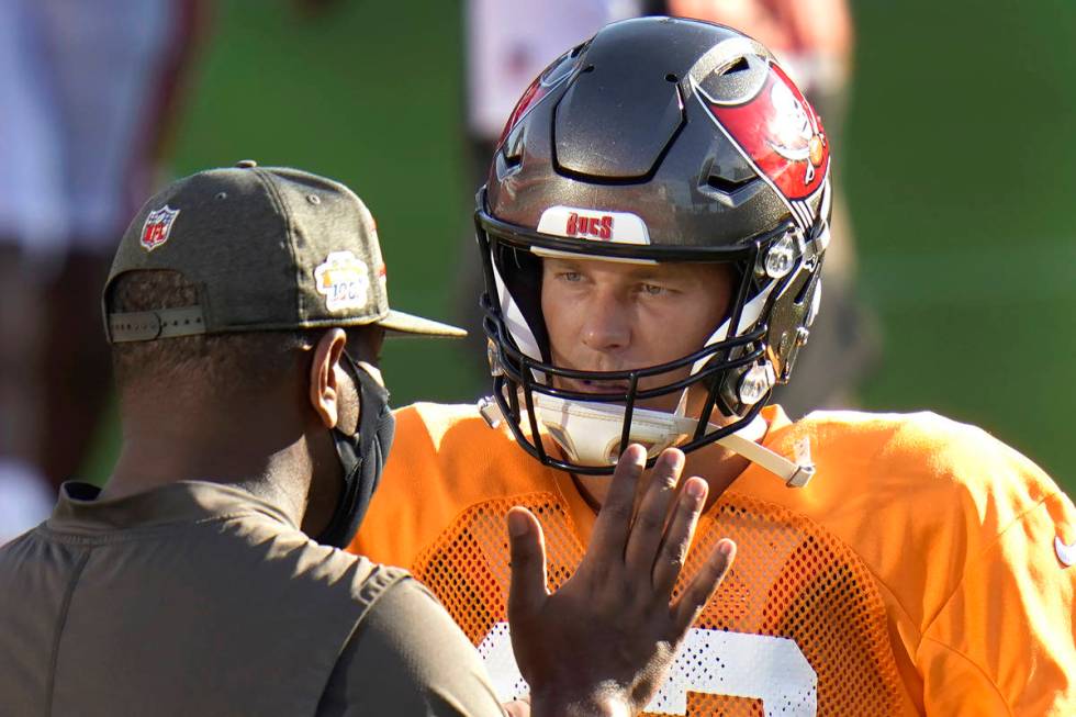 Tampa Bay Buccaneers quarterback Tom Brady talks to offensive coordinator Byron Leftwich during ...