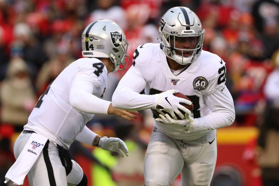 Oakland Raiders quarterback Derek Carr (4) hands off the football to running back Josh Jacobs ( ...