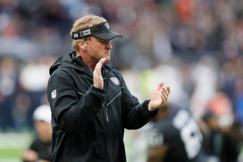 Oakland Raiders head coach Jon Gruden encourages his team as they prepare for an NFL football g ...