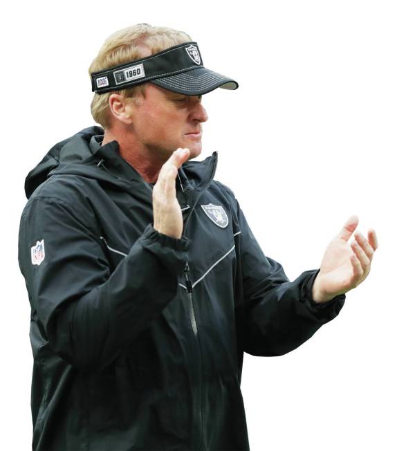 Oakland Raiders head coach Jon Gruden encourages his team as they prepare for an NFL football g ...