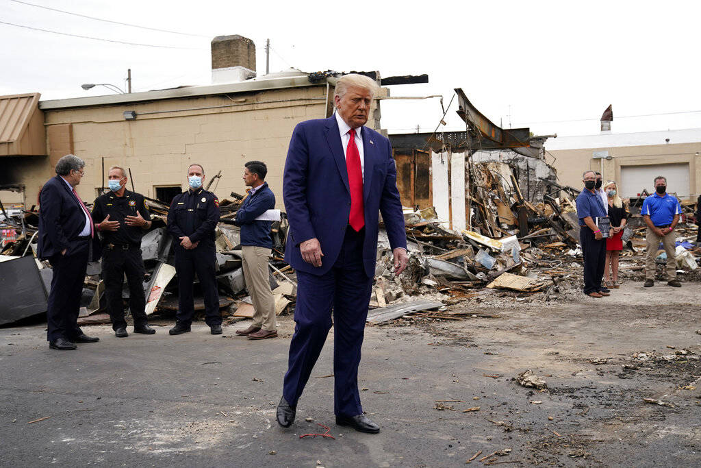 President Donald Trump tours an area Tuesday, Sept. 1, 2020, damaged during demonstrations afte ...