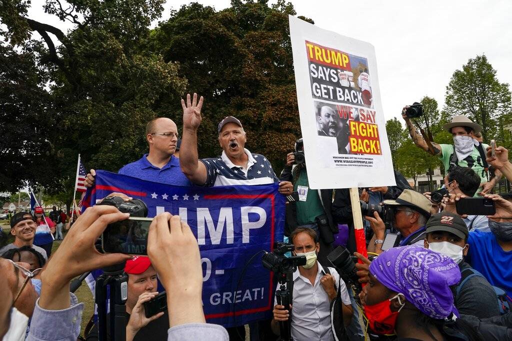 Supporters of both President Donald Trump and Black Lives Matters clash in a park outside the K ...