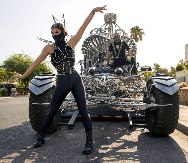 Joli Irvine, left, joins artist Henry Chang with kinetic art car Valyrian Steel as they prepare ...