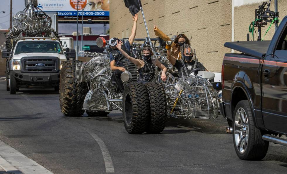 Artist Henry Chang, right, behind the wheel of his kinetic art car Mister Fusion while in a car ...