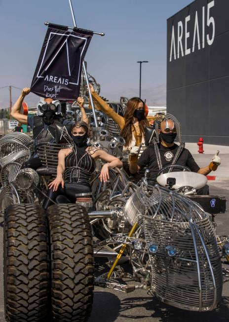 Artist Henry Chang, right, behind the wheel of his kinetic art car Mister Fusion leading a cara ...