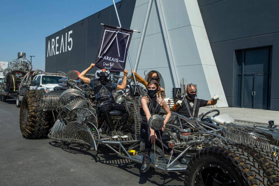 Artist Henry Chang, right, behind the wheel of his kinetic art car Mister Fusion leading a cara ...